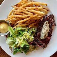 Chez Fonfon signature dishes Steak Frites, Moules Frites (Mussels and Fries), Hamburger Fonfon, Trout Amandine, Coconut Pecan Cake.
